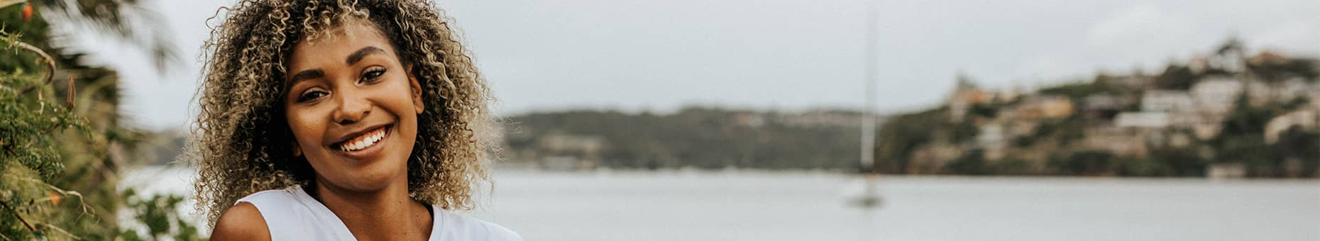 Women smiling on beach with youthful healthy skin