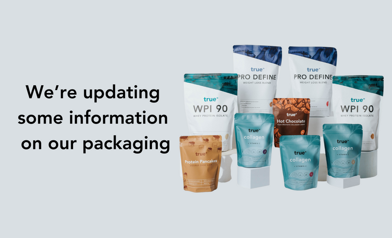 Banner showing True Nutrition product range on light grey background with text "We're updating some information on our packaging" — assorted True-branded pouches including WPI 90 whey protein isolate, Pro Define weight loss blend, collagen with vitamin C, protein pancakes and hot chocolate, product packaging update announcement.