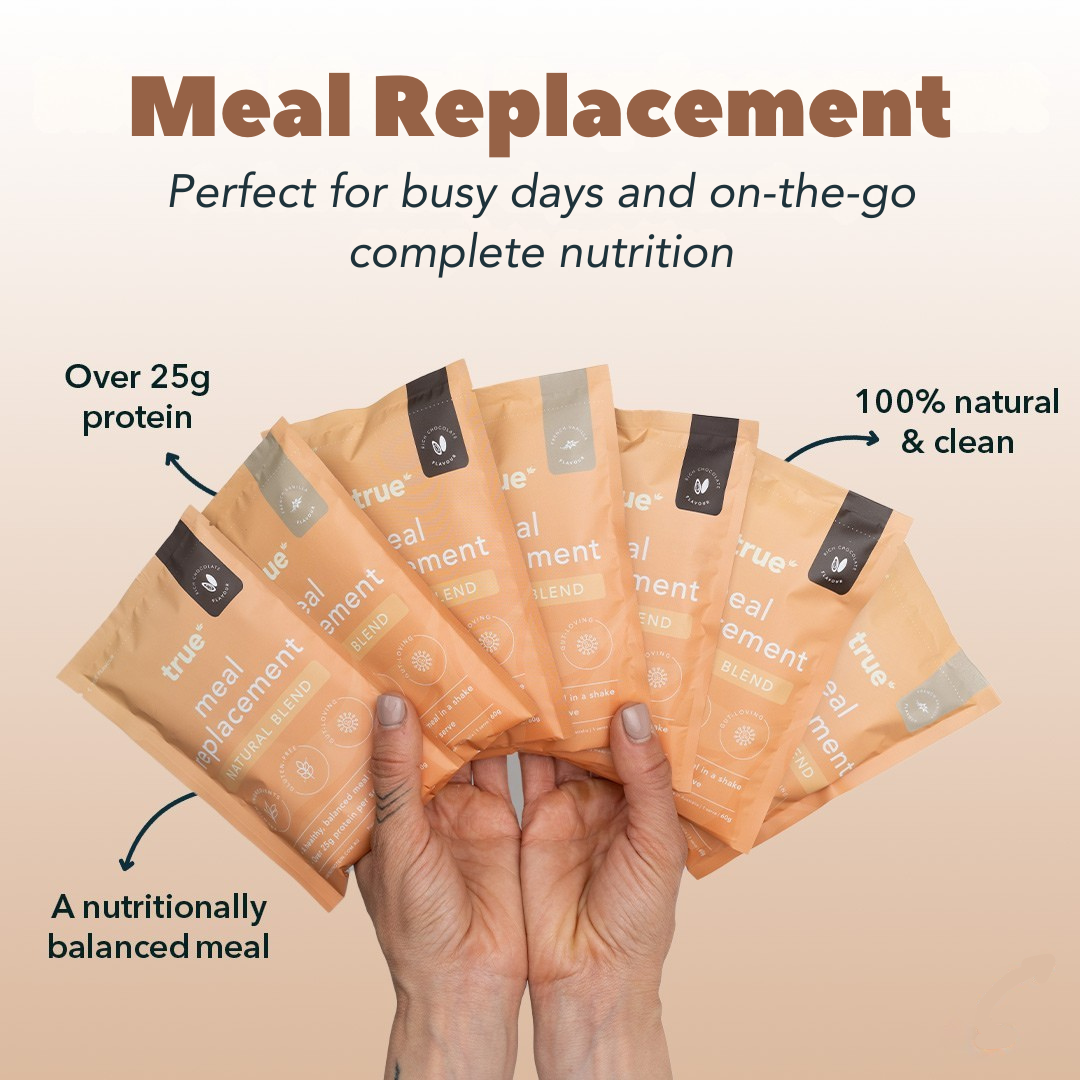 Image of six peach-coloured True Meal Replacement sachets fanned in hands, labeled "natural blend" and promoting "over 25g protein," "100% natural & clean" and "a nutritionally balanced meal" — convenient on-the-go nutrition.