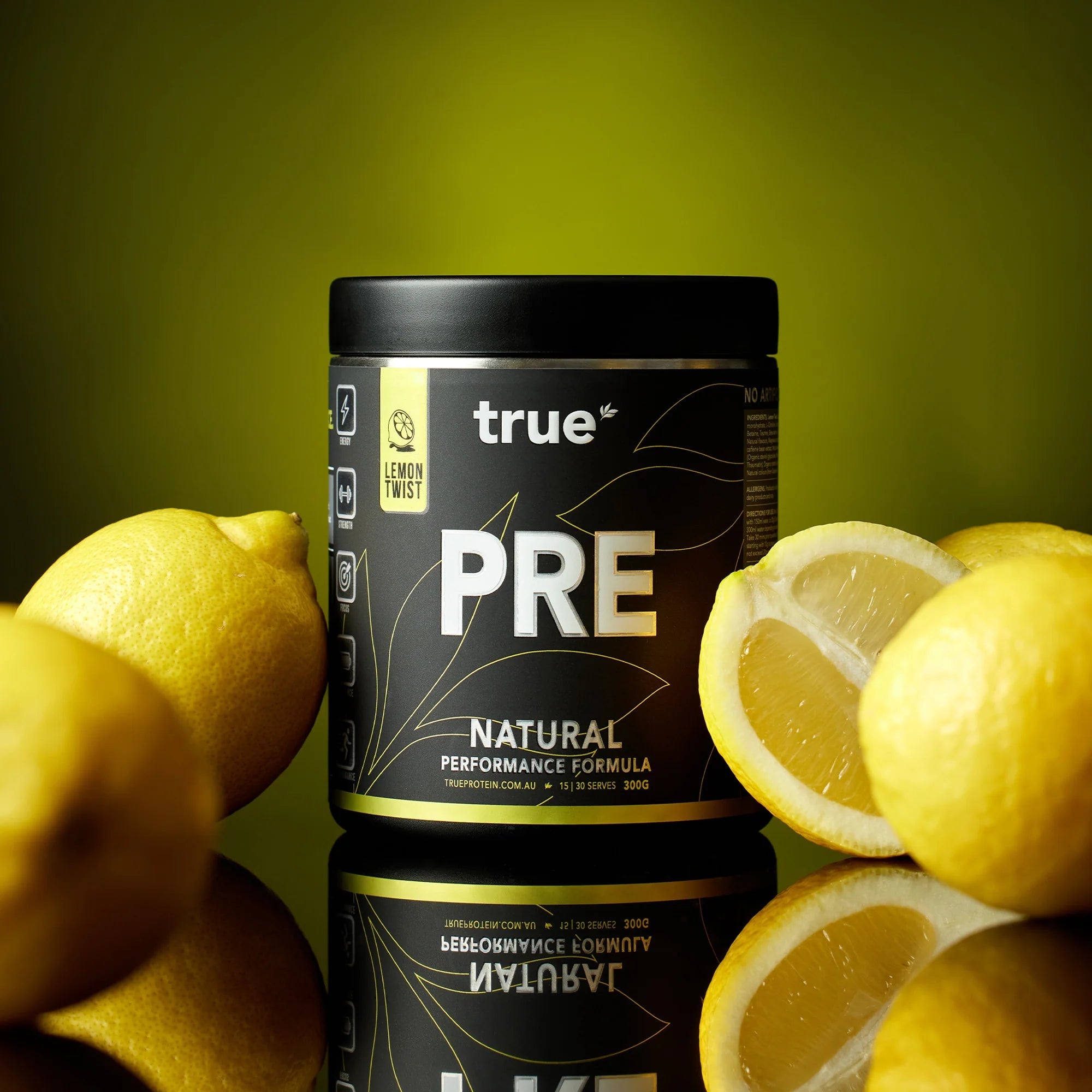 True PRE Natural Performance Formula pre-workout (Lemon Twist) 300g jar on reflective surface with fresh lemons, True Protein supplement (Australia)