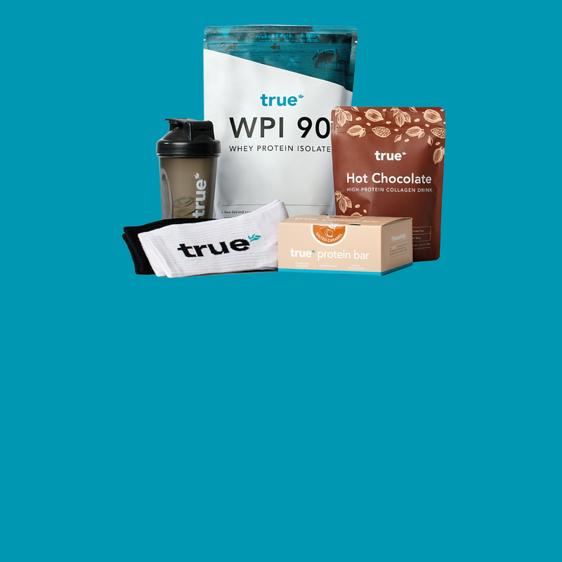 True gym bundle on teal background: True WPI 90 whey protein isolate pouch, True Hot Chocolate collagen drink pouch, True protein bar box, black True shaker bottle and white True socks — fitness supplement starter pack (New Zealand).