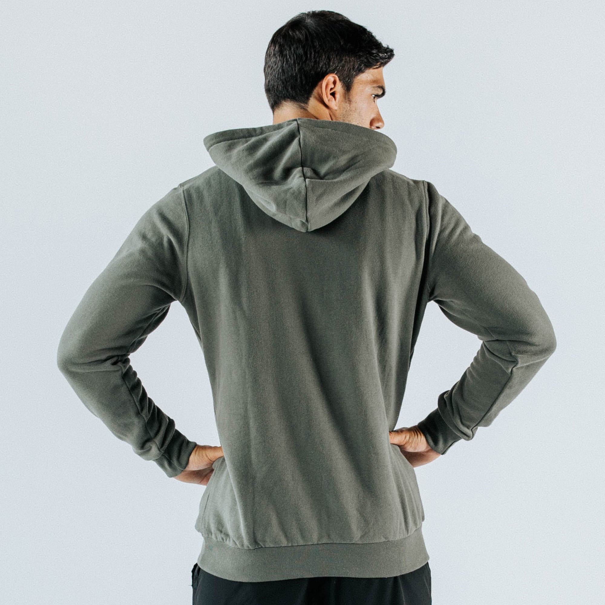 Men’s khaki pullover hoodie — back view on model, long-sleeve casual sweatshirt with hood and ribbed hem, lightweight cotton-blend, studio product photo for apparel e-commerce