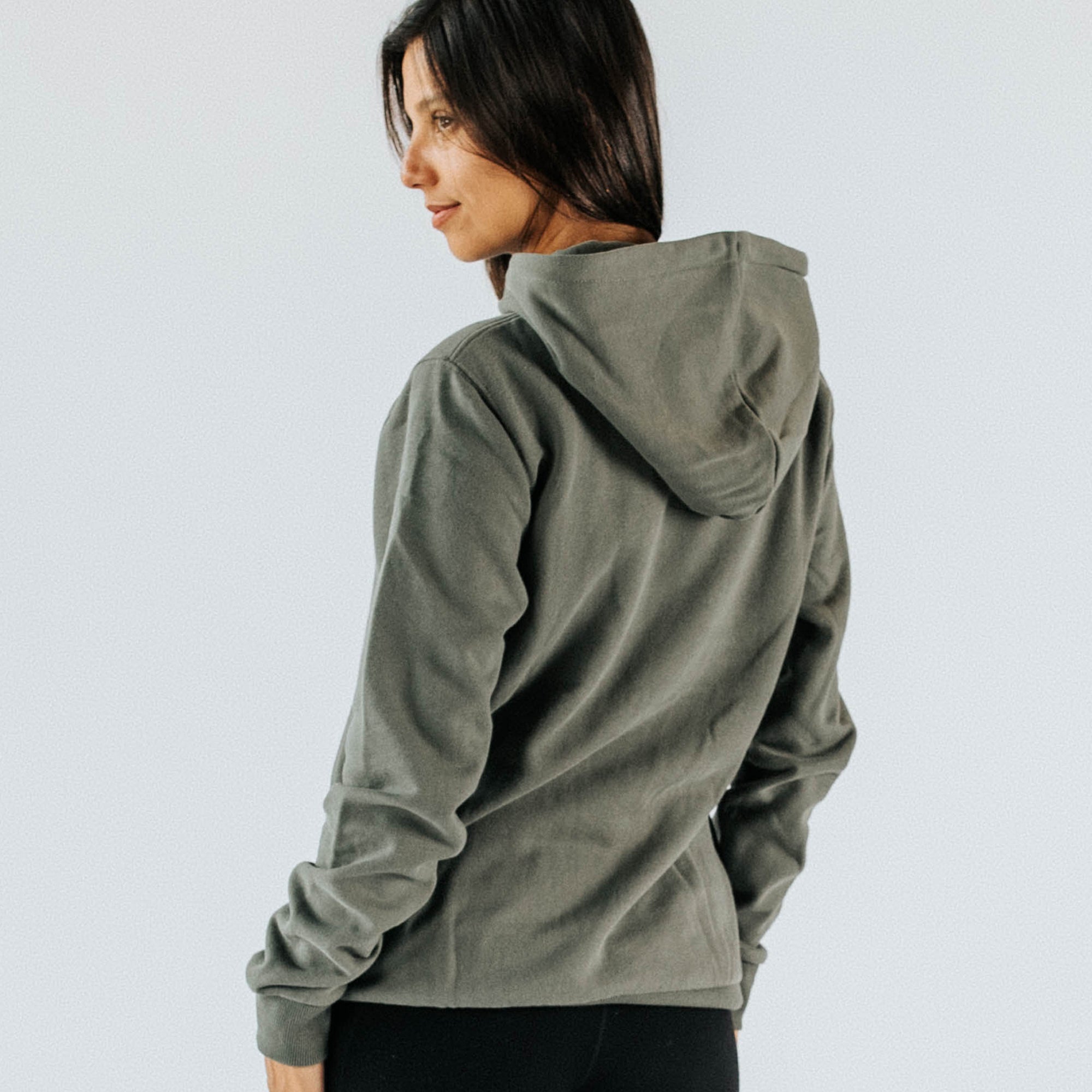 Women’s khaki pullover hoodie back view on model, lightweight cotton-blend casual activewear sweatshirt for everyday or outdoor wear, styled with black leggings.