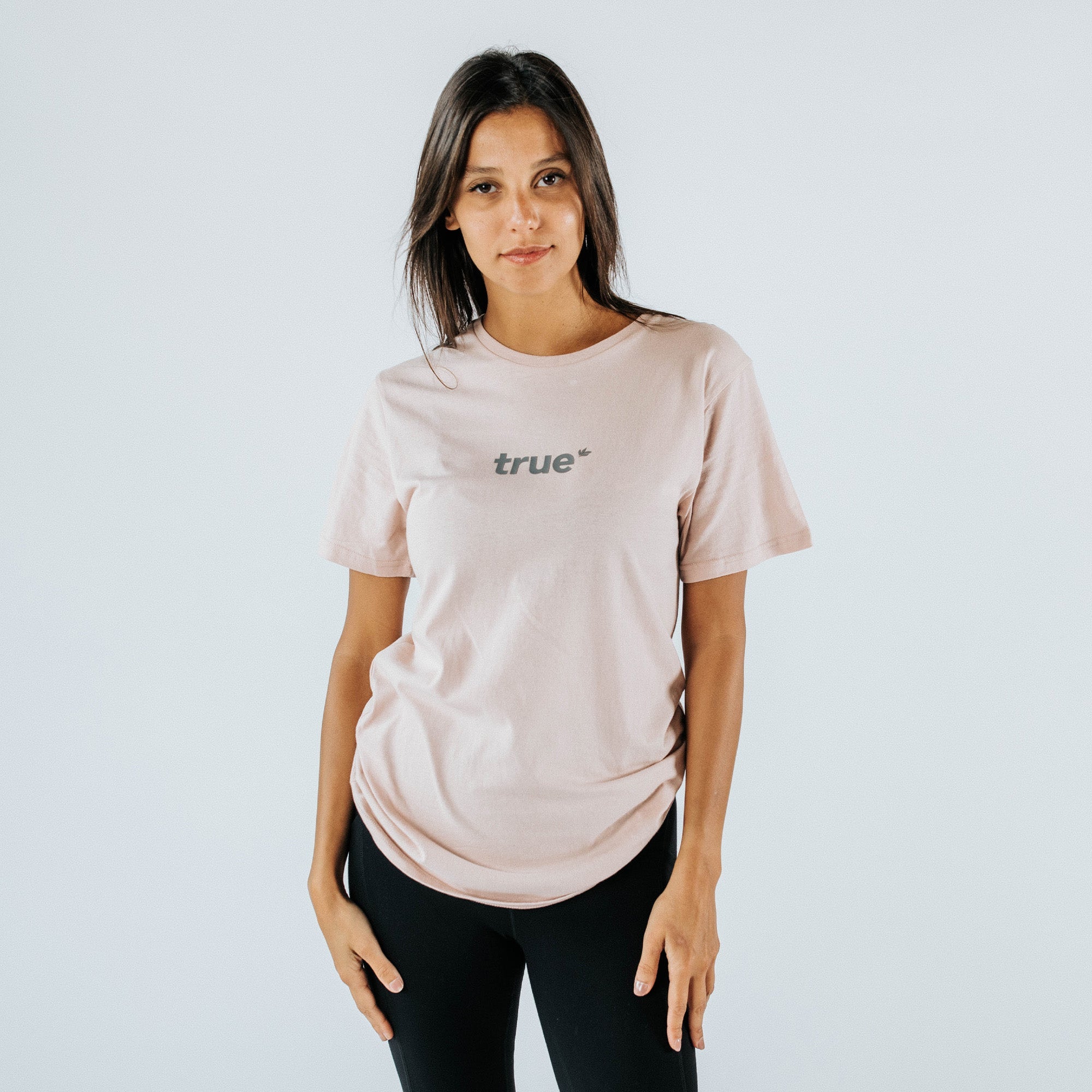 Woman wearing blush-pink "true" logo crewneck t-shirt, front view on model with black leggings, casual women&