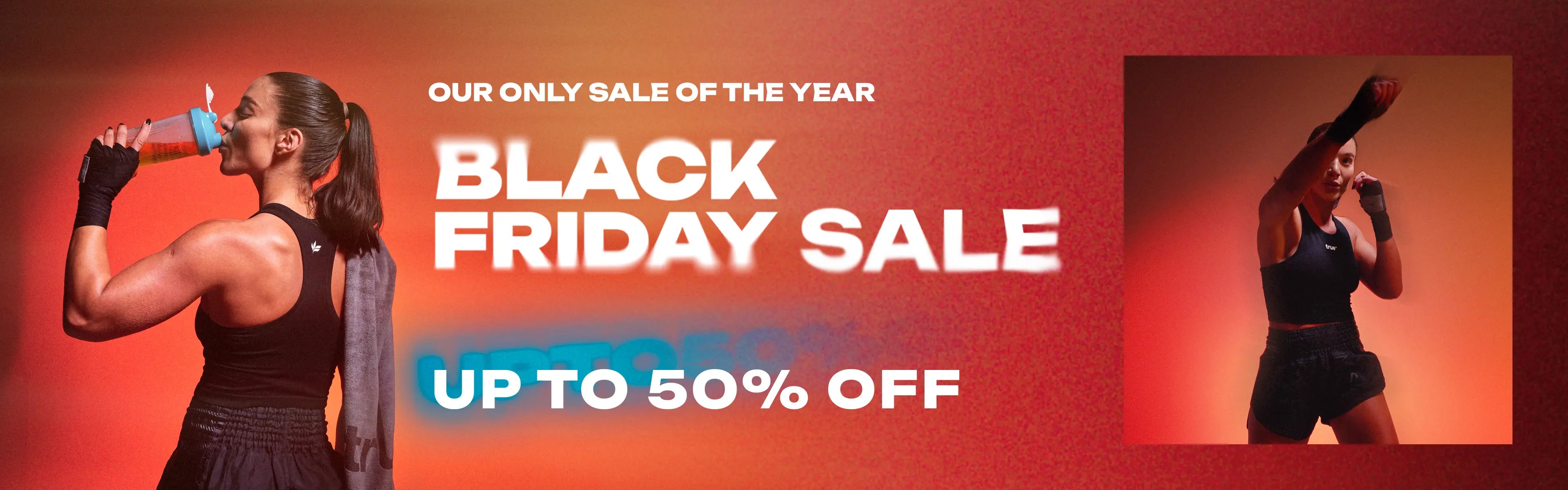 Black Friday sale banner for fitness apparel: muscular woman drinking from shaker bottle and female boxer in training pose on red-orange background, text "Black Friday Sale — Up to 50% off", shop online fitness gear.