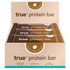 Box of 12 True Protein Bar – Choc Peanut Butter flavor, brown display box with three individually wrapped bars visible, 63g serving size, 18.0g protein per serving, front-facing retail packaging.